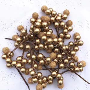 Golden artificial berries mix of smooth and frosted textures for wedding decoration