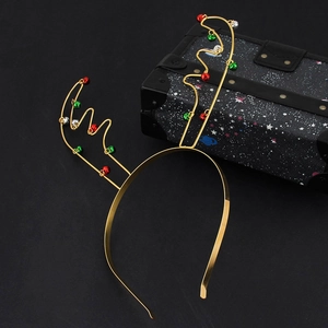 Golden Christmas reindeer antler headband with colorful bells on a dark background