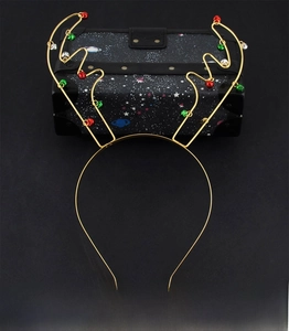 Detail of golden reindeer antler metal headband with colorful mini holiday bells