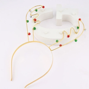 Detailed view of golden metal reindeer antler headband with colorful festive bells