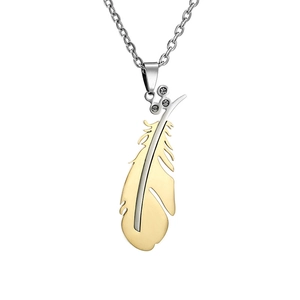 Macro detail of angel feather pendant in gold and silver finish with small diamonds