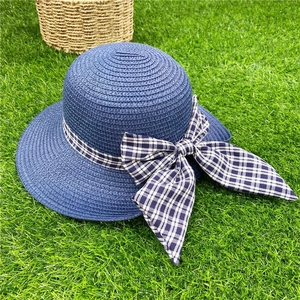 Navy blue woven straw beach hat with black and white checkered bow tie for women