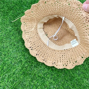 Handwoven straw sun hat for children with wavy brim and 100 percent paper fiber