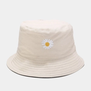 Detail of white daisy embroidery on beige canvas bucket hat with stitched brim texture