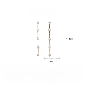 Detail view of long pearl drop earrings showing 8.6cm length and gold chain dimensions