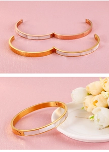 Detail of 6mm stainless steel shell bangles in rose gold and yellow gold finishes