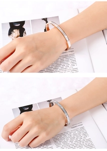 Detailed view of polished 6mm stainless steel shell bangles in rose gold and silver colors