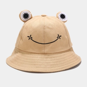 Detail of khaki cotton frog bucket hat featuring 3D eyes and embroidered smile