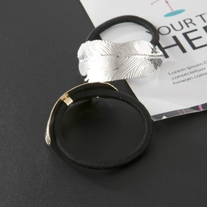 Silver metallic leaf hair tie set with elastic bands on a minimalist background