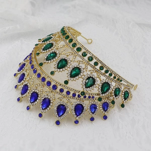 Detailed side view of golden Baroque bridal crown with green and blue water-drop crystals