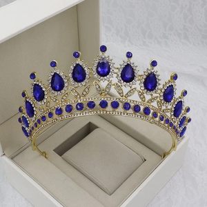 Detail of blue teardrop gemstones and crystals on golden bridal crown in jewelry box