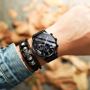 Close-up of Gadyson men's quartz watch with black mesh strap and woven leather bracelet