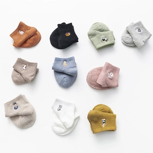 Ten pairs of multi-color cotton socks with cute animal embroidery on white background