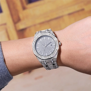 Silver full diamond wristwatch with octagonal bezel and date display on a wrist