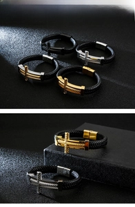 Close-up of woven black leather bracelets featuring engraved metal crosses in diverse tones