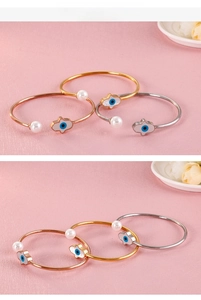 Détail de l'ensemble de bracelets œil protecteur et perle en finitions or et argent