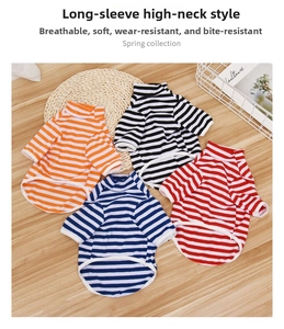 Flat lay view of striped high-neck dog sweaters in multiple colors on a wooden table