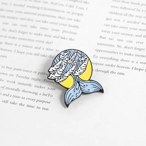 Artistic fish-shaped enamel pin with sea waves on a book, creative gift accessory