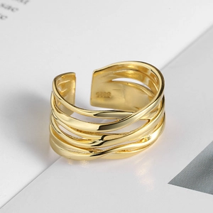 Detailed macro view of S925 sterling silver hallmark on golden interlaced band