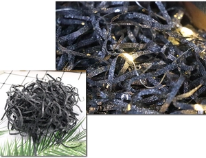 Detail of shimmering black glitter shredded raffia paper filler for gift boxes