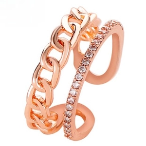 Detailed macro view of rose gold layered ring featuring a curb chain and micro pavé crystals