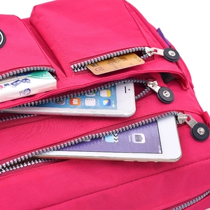 Large rose red waterproof nylon crossbody bag with multiple zipper compartments for storage
