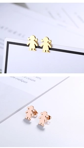 Detail view of gold and rose gold stainless steel earrings featuring a girl shape design
