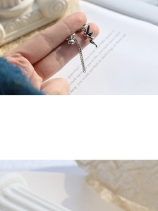 Detail view of vintage silver chain ear cuff with delicate angel fairy pendant charm