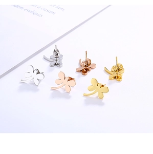 Detailed view of polished dragonfly earrings in gold, silver and rose gold finishes