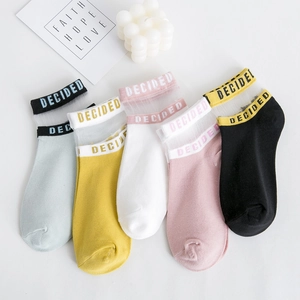 Flat lay view of cotton ankle socks in five colors featuring transparent mesh and DECIDED text