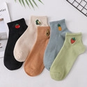 Flat lay of five cotton socks in assorted colors featuring cute fruit embroidery details