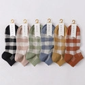 Detailed flat lay of six pairs of plaid cotton ankle socks in various vibrant colors