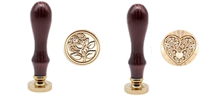 Detail of rose and heart pattern wax sealing stamps with wooden handles and brass heads
