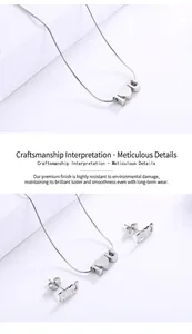 Detail of silver clover jewelry set with I Heart U charms and snake chain necklace