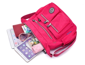 Macro view showing large capacity and multiple compartments of this rose red nylon bag