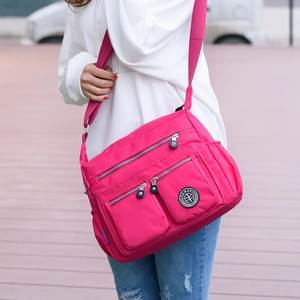 Waterproof rose red nylon crossbody bag with multiple pockets and adjustable strap