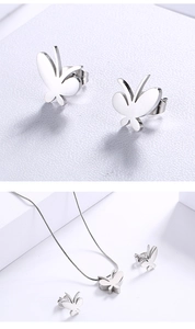 Detailed view of silver butterfly jewelry set featuring stud earrings and snake chain necklace