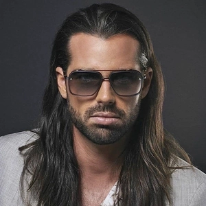 Close-up of model wearing rimless gradient sunglasses with metal double bridge frames