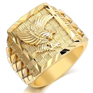 Detailed close-up of a men's gold plated eagle signet ring with intricate carvings