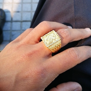 Detail of gold plated eagle relief and Greek fret pattern on a men's ring