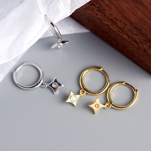 Detail of S925 silver star hoop earrings with sparkling zirconia in gold and silver
