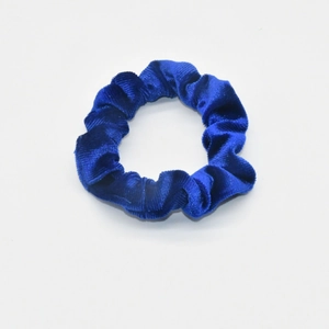 Macro detail of royal blue velvet scrunchie showing rich texture and soft fabric folds