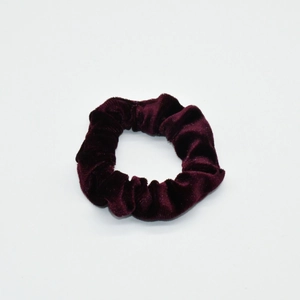 Detailed view of the soft velvet texture and pleats of the deep burgundy scrunchie