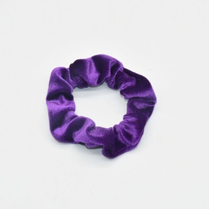 Close-up of violet velvet scrunchie showing rich fabric texture and elastic pleats