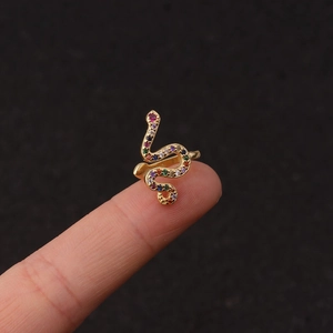 U-shaped gold snake ring with colorful zircon stones on black background