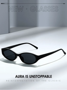 Detail of black oval sunglasses featuring a minimalist frame and dark tinted UV lenses