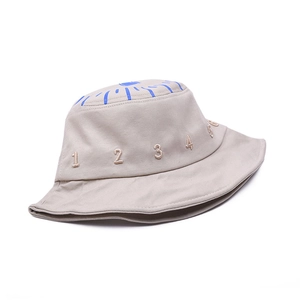 Detail of beige cotton canvas bucket hat with embroidered blue numbers and sun pattern