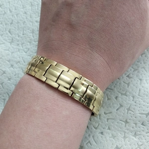 Gold-toned titanium magnetic chain bracelet for men displayed on a model wrist