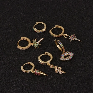 Bohemian gold hoop earrings set with colorful gemstones and star, palm, snake charms
