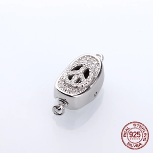 Macro detail of S925 sterling silver oval clasp with zircon-set peace sign pendant